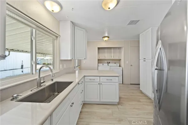 a kitchen with a sink cabinets and stainless steel appliances