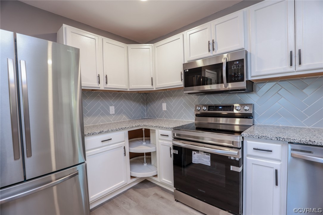 3309 Croydon Road Richmond, VA 23223 - Photo 10 of 21 Kitchen featuring backsplash, white cabinetry, lig