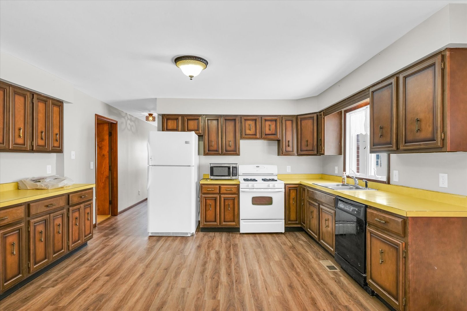 103 South Walnut Street Arrowsmith, IL 61722 - Photo 16 of 39 a kitchen with a stove a sink and a refrigerator