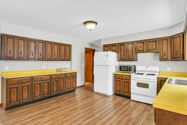 a kitchen with wooden cabinets and a stove top oven