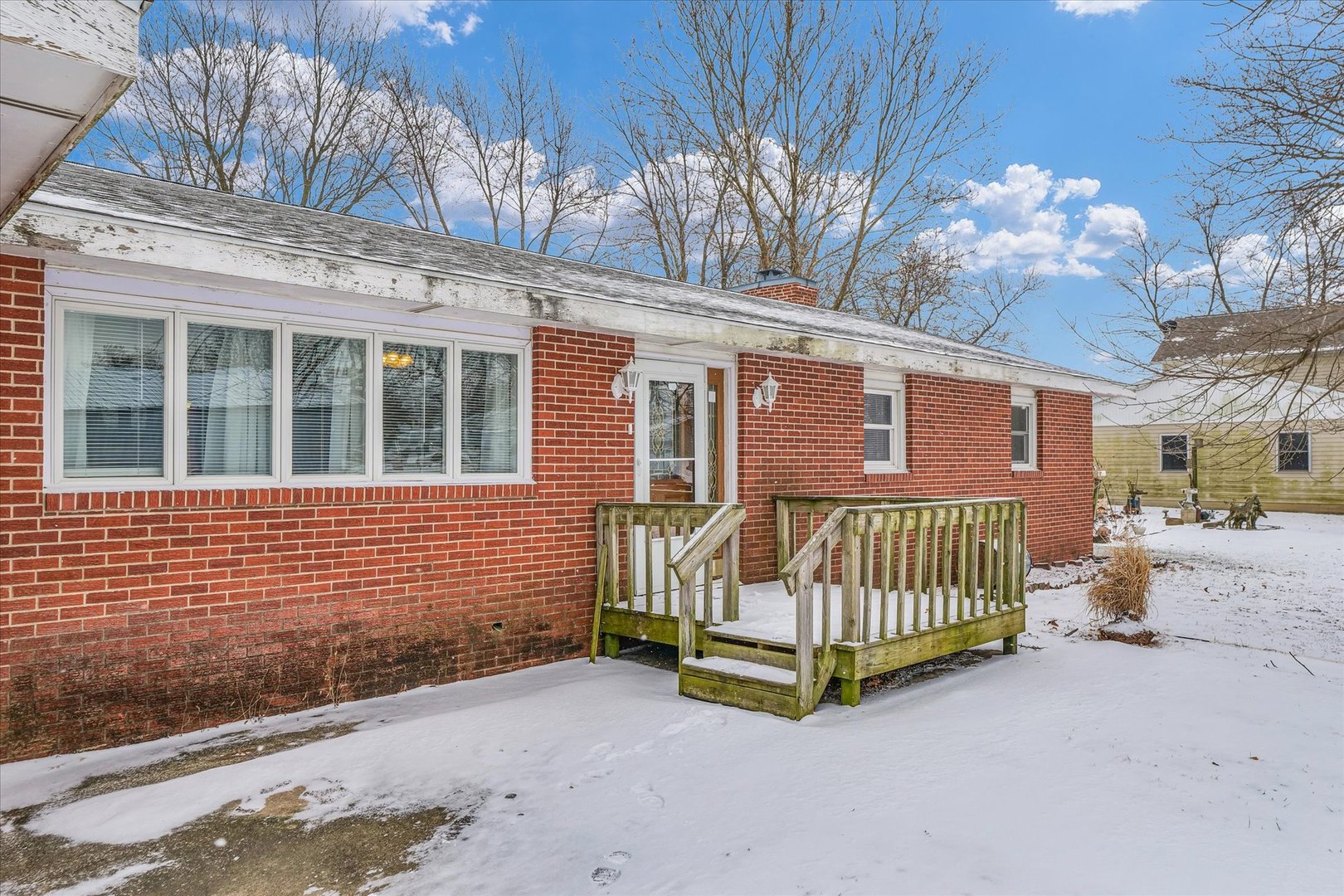 103 South Walnut Street Arrowsmith, IL 61722 - Photo 38 of 39 a view of a brick house with large windows and a large tree