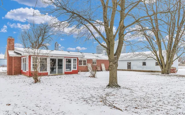 a view of a house with a snow in the yard