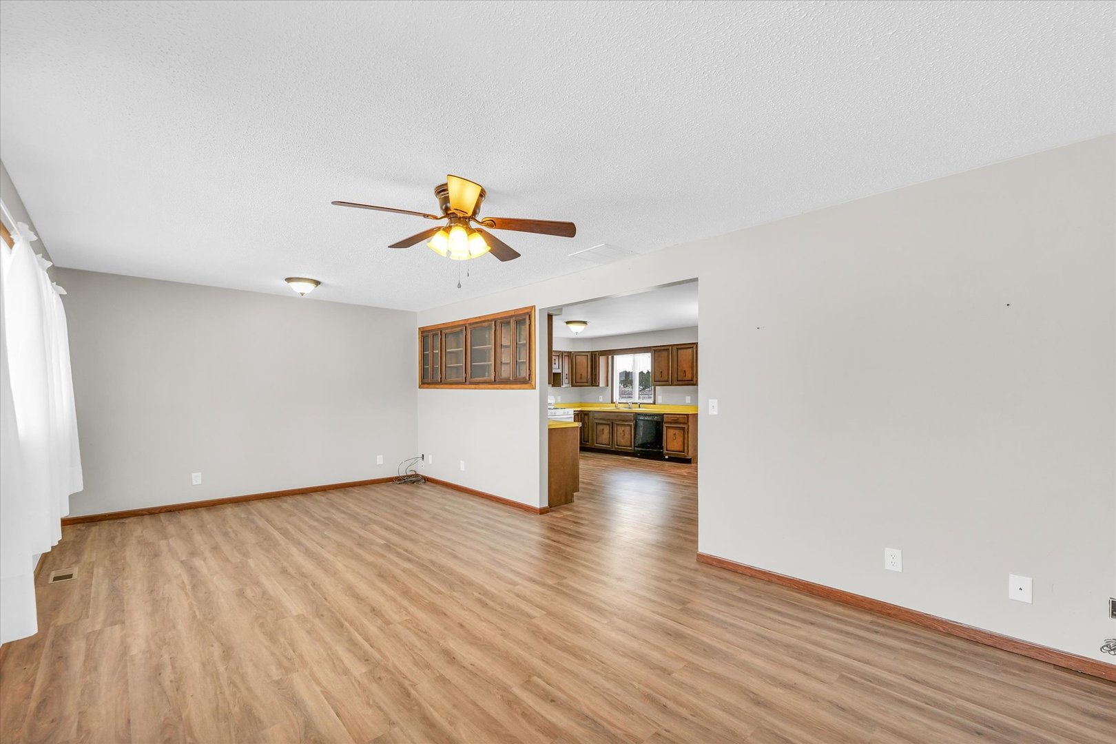 103 South Walnut Street Arrowsmith, IL 61722 - Photo 10 of 39 a view of livingroom with wooden floor and a ceiling fan
