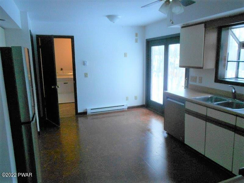 126 Maple Ridge Drive Hawley, PA 18428 - Photo 17 of 40 an empty room with wooden floor and a bathroom