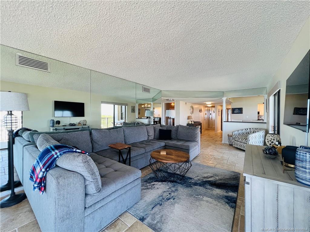 Undisclosed Address Jensen Beach, FL 34957 - Photo 26 of 86 a living room with furniture and a flat screen tv