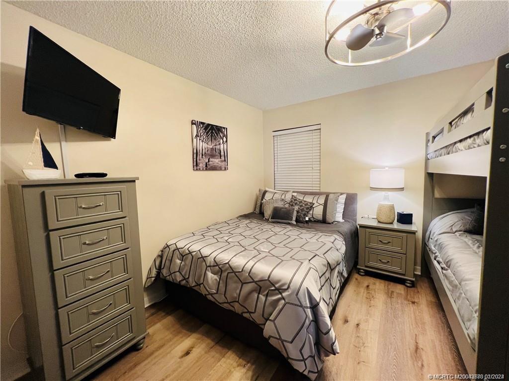 Undisclosed Address Jensen Beach, FL 34957 - Photo 58 of 86 a bedroom with a bed and a flat screen tv