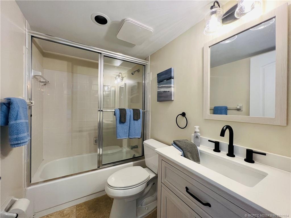 Undisclosed Address Jensen Beach, FL 34957 - Photo 61 of 86 a bathroom with a sink mirror toilet and shower