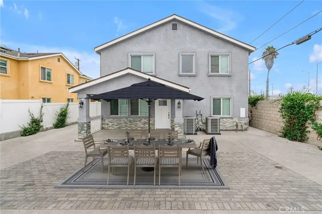 a living room with furniture and kitchen view with wooden floor