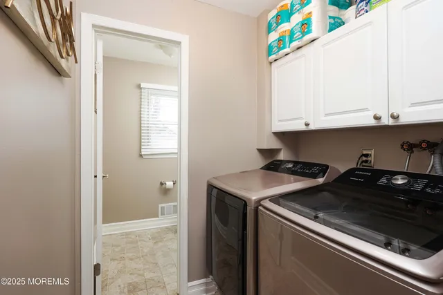 a spacious bedroom with a bed and a chandelier