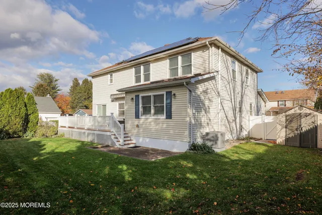 a backyard of a house with table and chairs