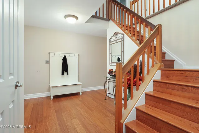 a view of entryway and hall with wooden floor