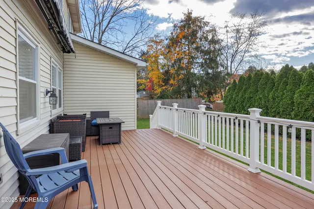 a view of a wooden deck with furniture