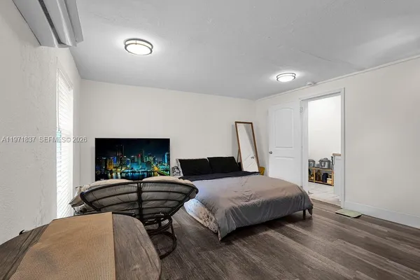 a bedroom with two beds and a lamp