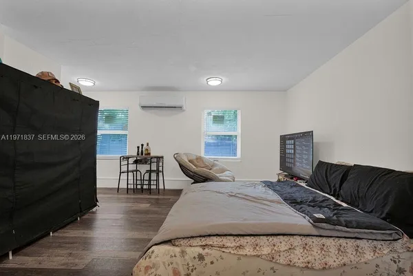 a bedroom with furniture and wooden floor
