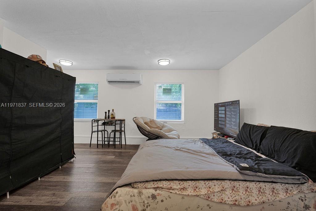 3010 Northwest 95th Terrace, Unit B Miami, FL 33147 - Photo 4 of 6 a bedroom with furniture and wooden floor