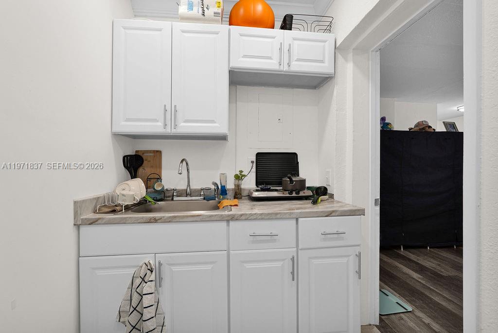 3010 Northwest 95th Terrace, Unit B Miami, FL 33147 - Photo 5 of 6 a kitchen with stainless steel appliances a sink and cabinets