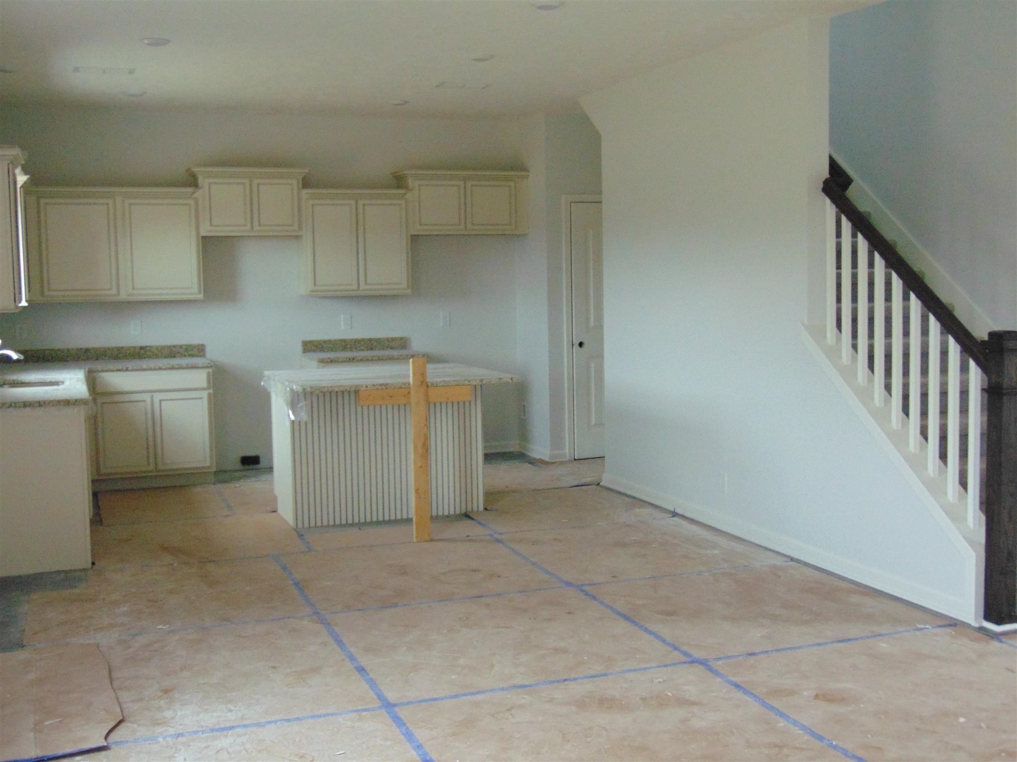 285 Spring Street La Vergne, TN 37086 - Photo 6 of 12 a kitchen with a stove top oven cabinets and a refrigerator