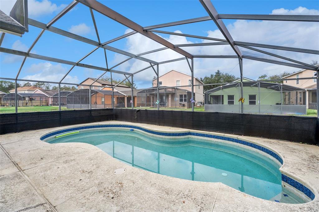 1755 Royal Ridge Drive Davenport, FL 33896 - Photo 17 of 25 a view of a swimming pool with a yard and potted plants