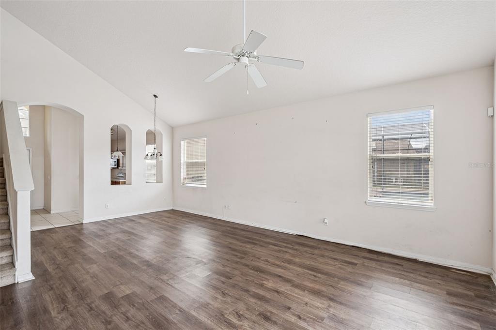 1755 Royal Ridge Drive Davenport, FL 33896 - Photo 3 of 25 an empty room with wooden floor a ceiling fan and windows