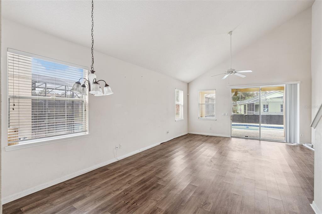 1755 Royal Ridge Drive Davenport, FL 33896 - Photo 4 of 25 a view of an empty room with a window and wooden floor