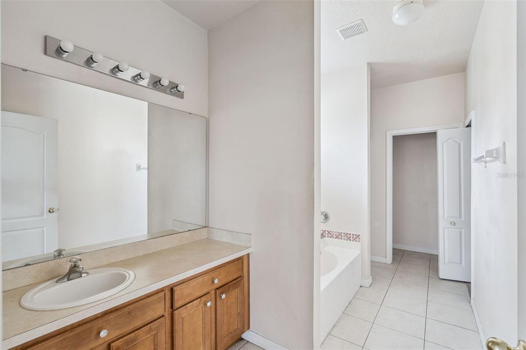 1755 Royal Ridge Drive Davenport, FL 33896 - Photo 8 of 25 a bathroom with a sink and a mirror