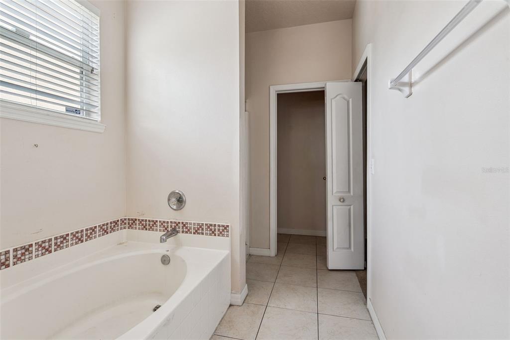 1755 Royal Ridge Drive Davenport, FL 33896 - Photo 9 of 25 a bathroom with a bathtub and a shower
