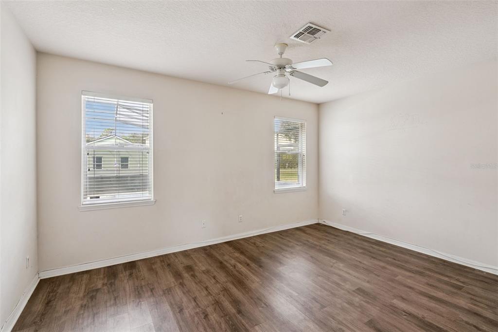 1755 Royal Ridge Drive Davenport, FL 33896 - Photo 10 of 25 a view of an empty room with wooden floor and a window