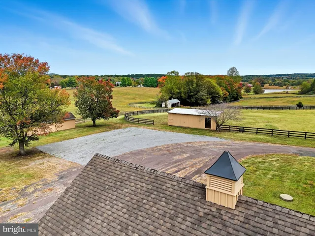 a large kitchen with stainless steel appliances wooden floors and wooden cabinets
