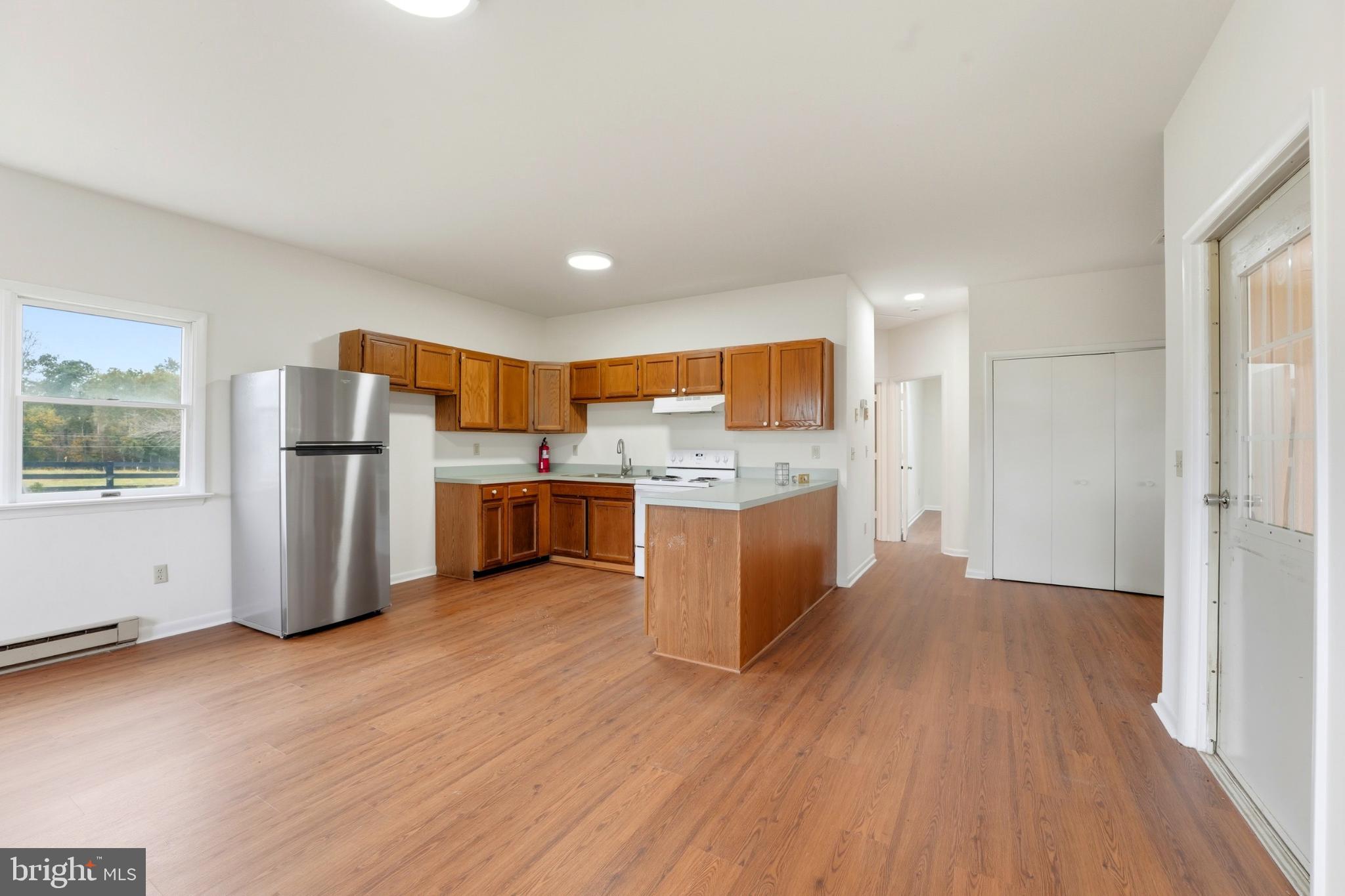8021 Olympic Way Culpeper, VA 22701 - Photo 52 of 78 a large kitchen with stainless steel appliances wooden floors and wooden cabinets