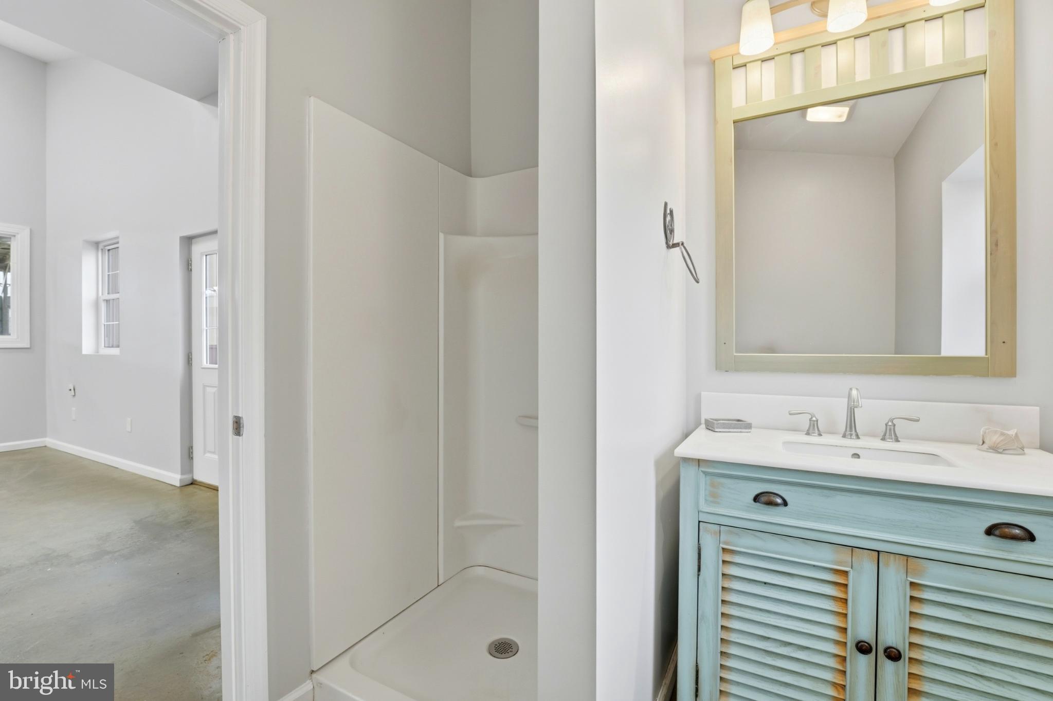 8021 Olympic Way Culpeper, VA 22701 - Photo 69 of 78 a bathroom with a sink and a mirror