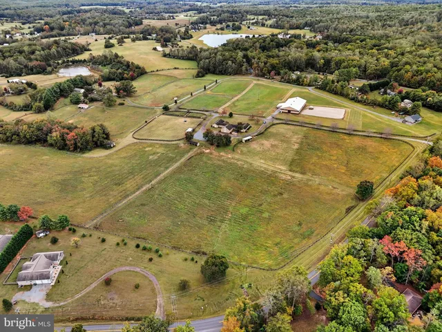 an aerial view of a house with big yard