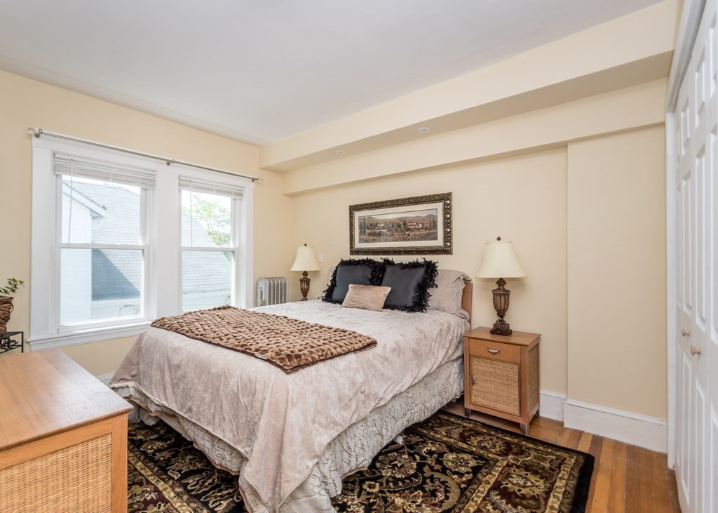 16 Hamblin Road, Unit 2 Waltham, MA 02453 - Photo 13 of 29 a bedroom with a bed and a window with chair