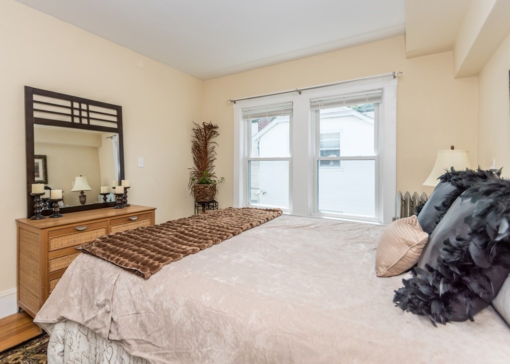 16 Hamblin Road, Unit 2 Waltham, MA 02453 - Photo 17 of 29 a bedroom with a bed and a dresser next to a window