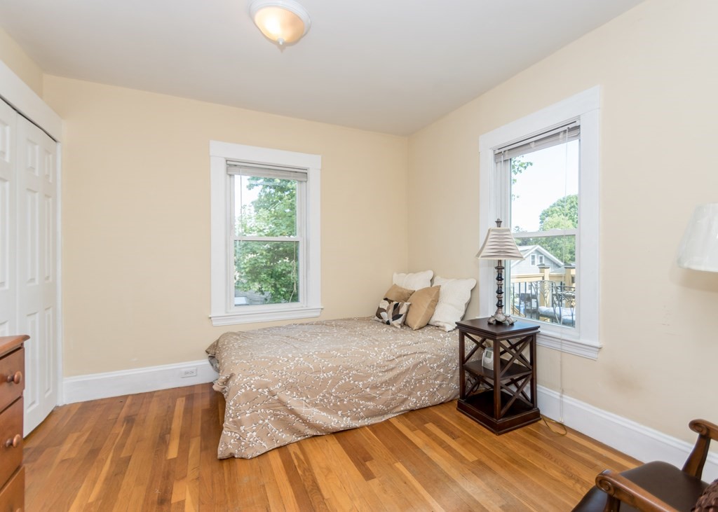 16 Hamblin Road, Unit 2 Waltham, MA 02453 - Photo 20 of 29 a bed sitting in a bedroom next to a window