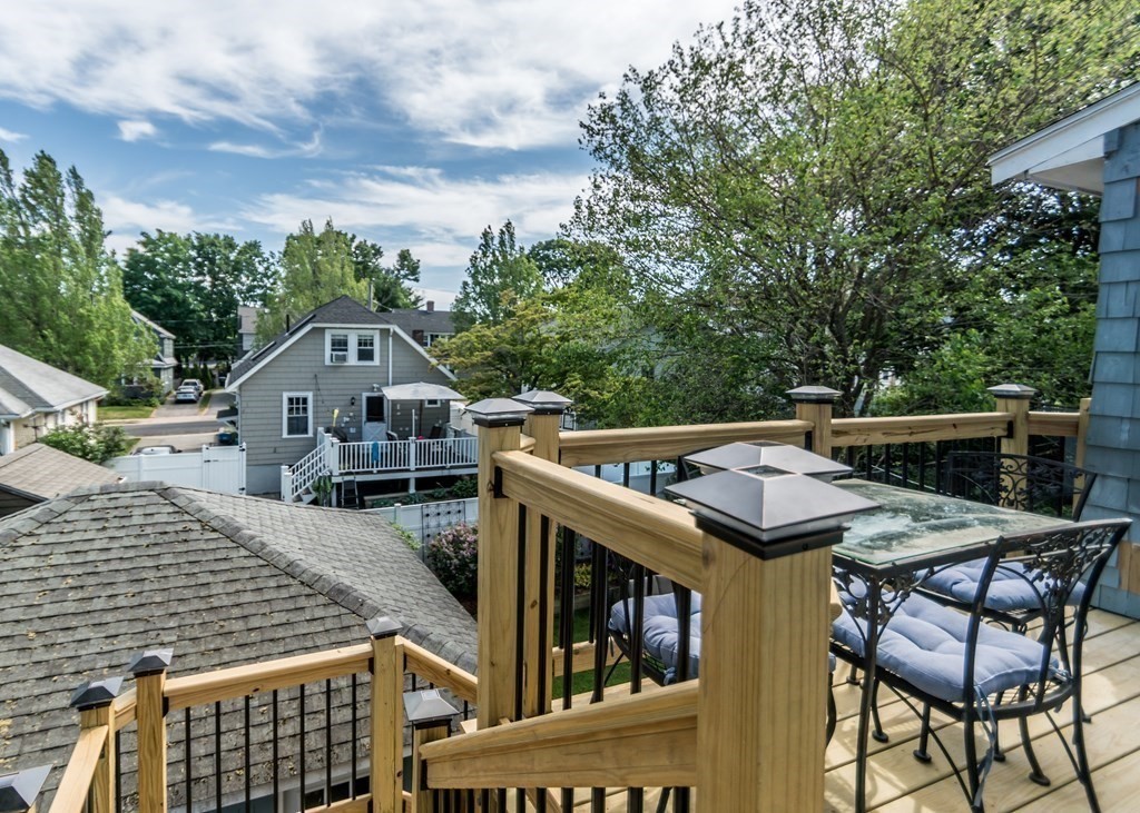 16 Hamblin Road, Unit 2 Waltham, MA 02453 - Photo 24 of 29 a terrace of a house with wooden table and chairs