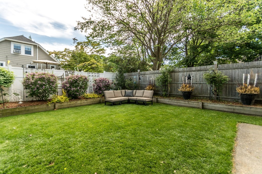 16 Hamblin Road, Unit 2 Waltham, MA 02453 - Photo 28 of 29 a backyard of a house with table and chairs