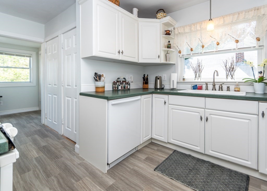 16 Hamblin Road, Unit 2 Waltham, MA 02453 - Photo 5 of 29 a kitchen with granite countertop white cabinets and white appliances