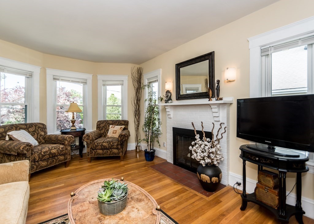 16 Hamblin Road, Unit 2 Waltham, MA 02453 - Photo 9 of 29 a living room with furniture a flat screen tv and a fireplace