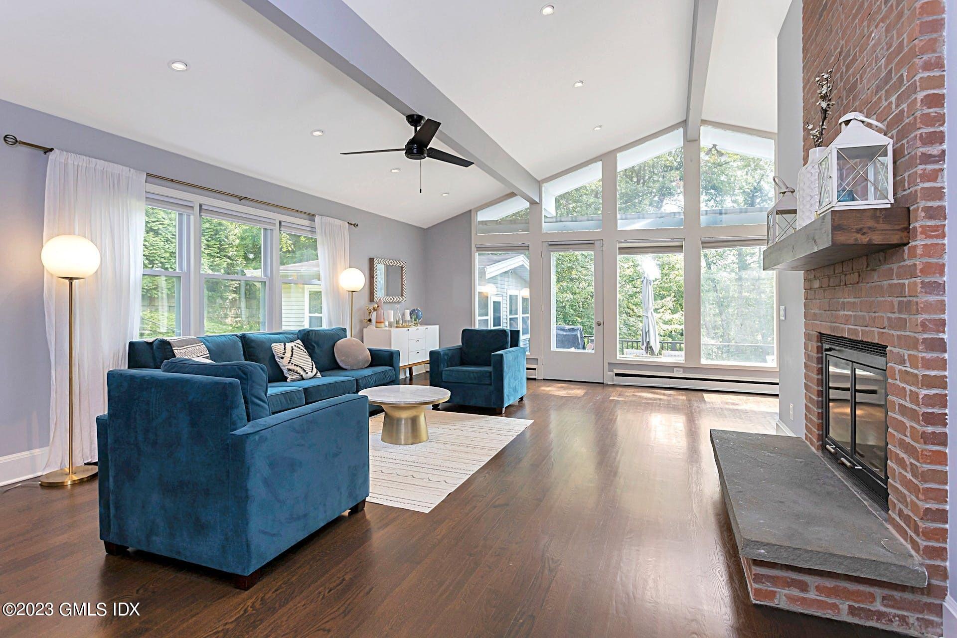 396 Westover Road Stamford, CT 06902 - Photo 7 of 39 a living room with furniture a large window and a fireplace