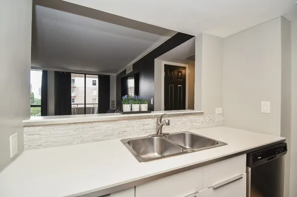 a kitchen with granite countertop cabinets stainless steel appliances and a counter space