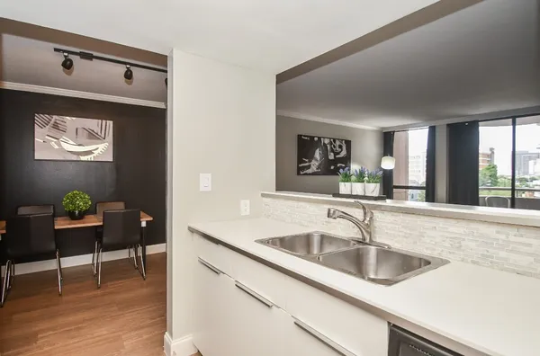 a kitchen with stainless steel appliances granite countertop a sink and a refrigerator