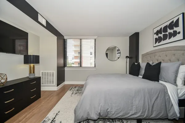 a bedroom with a bed and a window