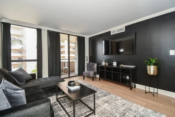 a living room with furniture and wooden floor