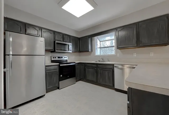 a kitchen with a refrigerator stove and microwave