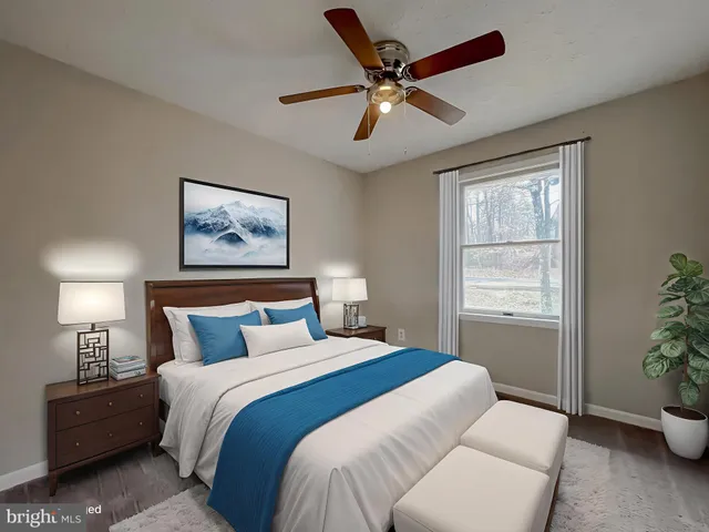 a bedroom with a bed and a potted plant