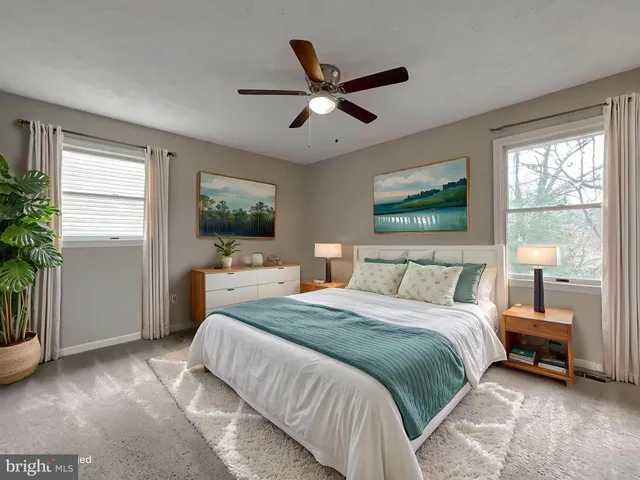 a spacious bedroom with a bed and a large window