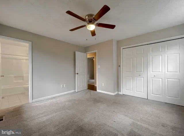 a view of an empty room with a ceiling fan