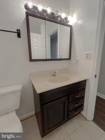 a bathroom with a sink vanity and a mirror