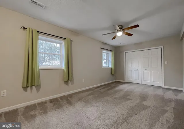 a view of empty room with windows