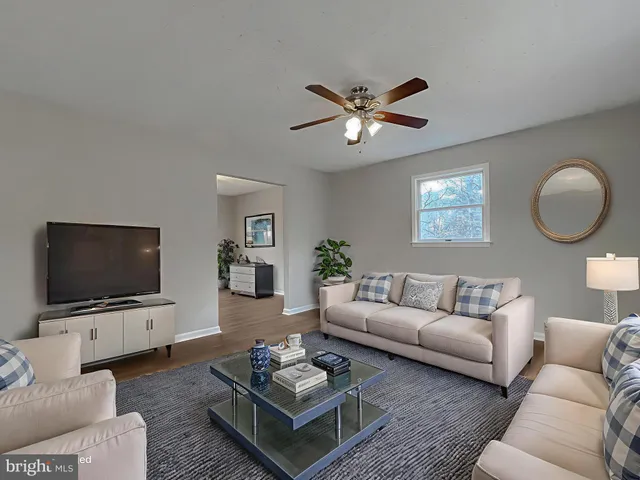 a living room with furniture a rug and a flat screen tv